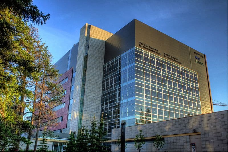 A tall, modern concrete building on the University of Alberta campus
